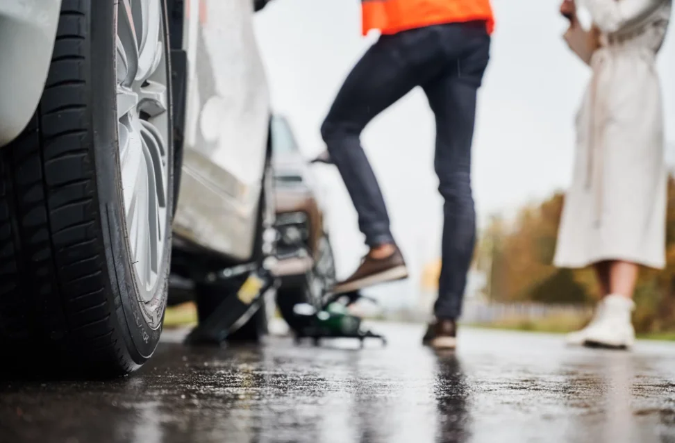 emergency auto mechanic repairing woman vehicle